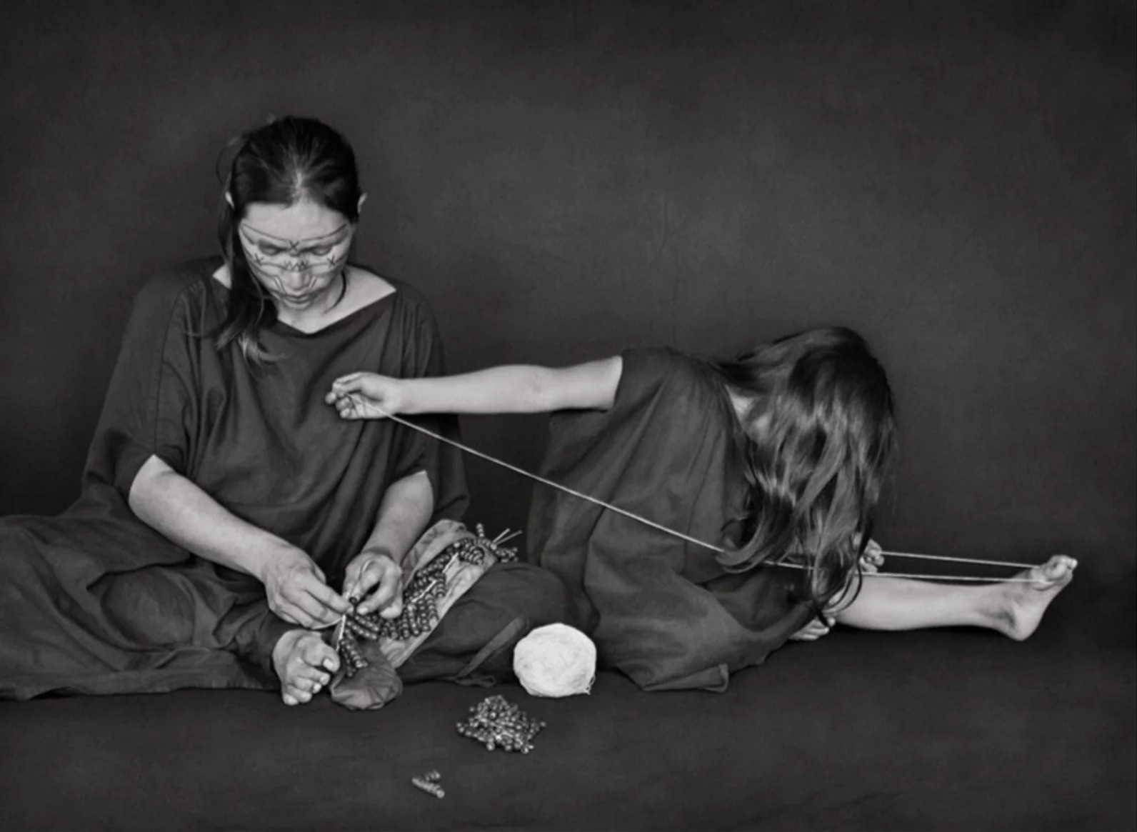 Sebastião Salgado, Auzelina Piyãko Asháninka and daughter making seed necklaces. Kampa do Rio Amônea Indigenous Territory, state of Acre (M) Sebastião Salgado, Auzelina Piyãko Asháninka and daughter making seed necklaces. Kampa do Rio Amônea Indigenous Territory, state of Acre (M)